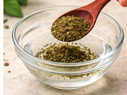 Spooning the botanical blend into a bowl of water